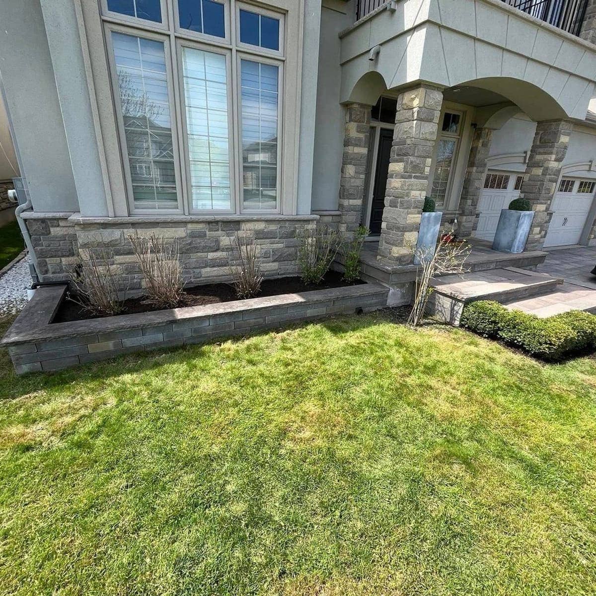 Fresh interlock walkway and tidy garden bed at a home in Hamilton